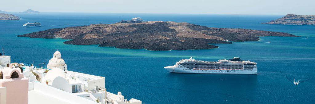 Beautiful ocean view with cruise ships and islands in the background.