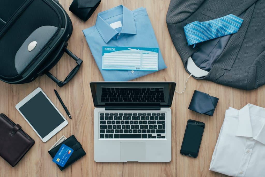 Travel packing list with clothes, electronics, and documents for cruise.