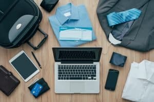 Travel packing list with clothes, electronics, and documents for cruise.